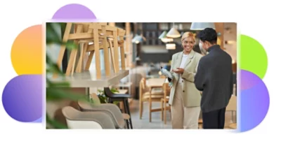 A furniture salesperson speaking with a customer in a showroom.