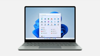 A front view of Surface Laptop Go 2 in Sage displays the Windows 11 start screen
