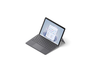 A 3/4 view from slightly above of Surface Go 3 in Platinum with a Surface Type Cover attached.