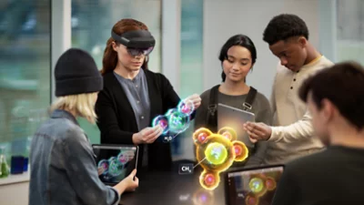 Group of people holding tablets and animated graphics as virtual display