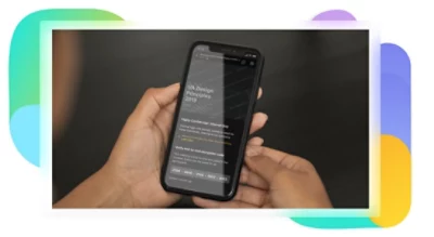 A mobile phone displaying a presentation with sensitivity labels present on the content.