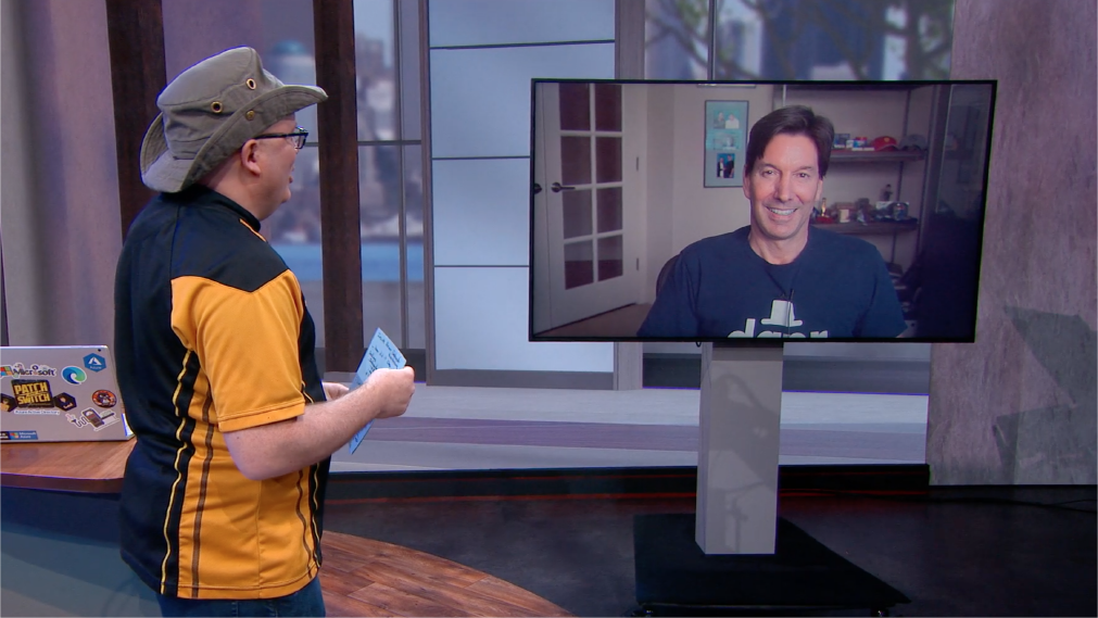 Man with a hat speaking to another man in a screen.