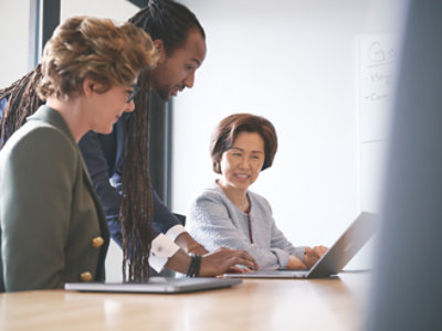 A group of people looking at a computer