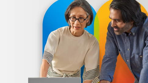 Man and woman standing and looking at a computer together