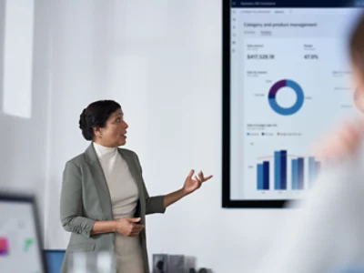 A person giving a presentation in a big screen