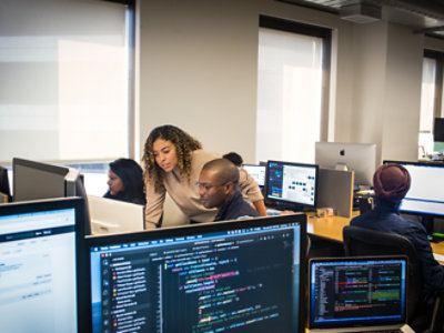 A group of people working on computers in an office