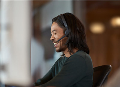 A person wearing headphones and smiling