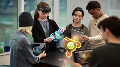 A group of students viewing large atoms in augmented reality with HoloLens 2.