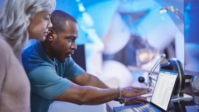 Two person's looking at a computer