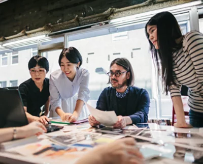 A group of people looking at papers