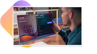 A person using a touchscreen monitor to sign in to Teams at a flexible workspace.