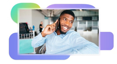 A person smiling and holding a mobile phone to their ear.
