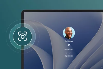 Partial view of Surface Laptop Studio 2 with a Windows Hello log in menu on screen and an eyeball icon floating above the device.