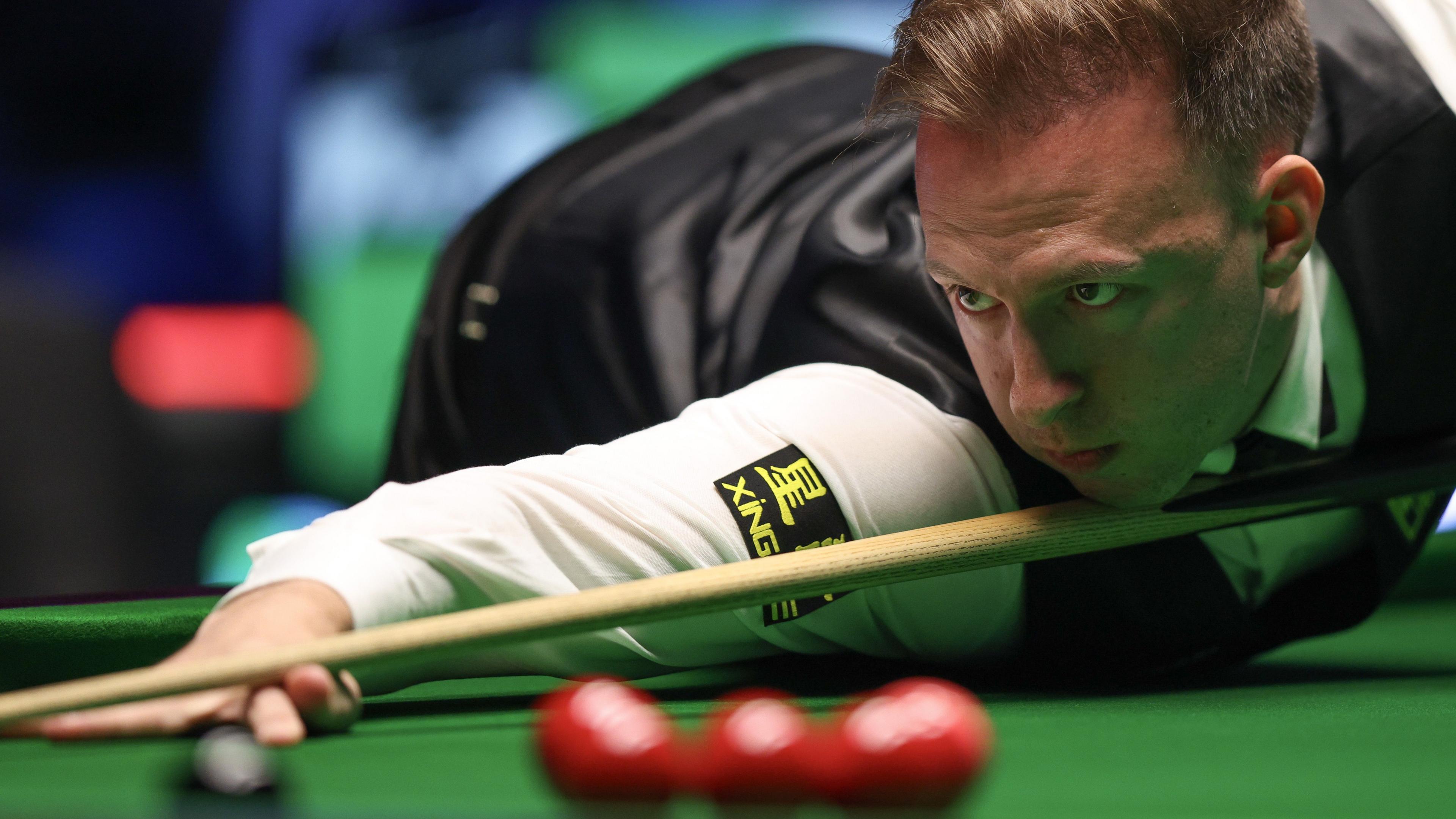 Judd Trump plays a shot