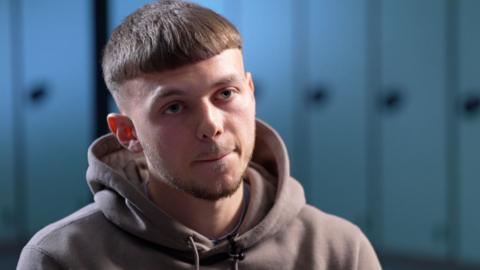 Jonathan Gjoshe during an interview wears a hoodie