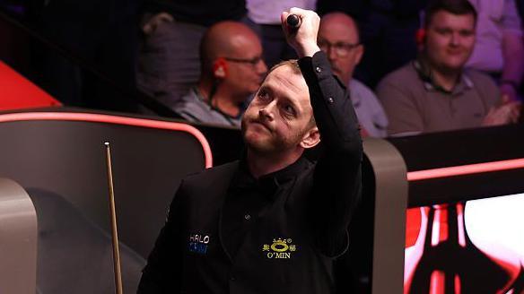 Mark Allen celebrates with his left arm raised
