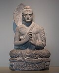 Seated Buddha in a gesture of preaching known as "turning the wheel of the doctrine"