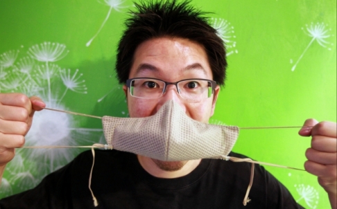 Kelvin Lau, a Chinese-Canadian, shows one of his face masks. Lau used to work as an engineer in Beijing, and now runs an online shop selling masks. (Photo: Simon Song)